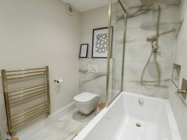 A bathroom with a bathtub and shower at Pengarnedd in Amlwch
