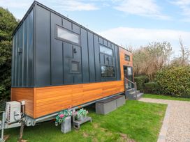A tiny home with steps and windows at The Tiny Home 