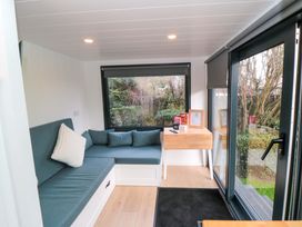 A living room with a sofa and table at The Tiny Home
