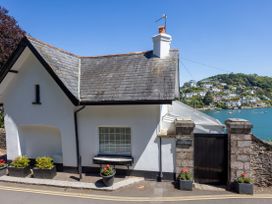 An exterior view of a house with a garden at Bell Cottage in Dartmouth