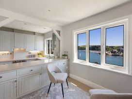 A kitchen with a window overlooking the harbor at Bell Cottage in Dartmouth