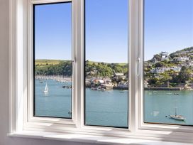 A window view of boats and hills at Bell Cottage in Dartmouth