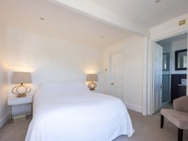 A bedroom with a bed and nightstands at Bell Cottage in Dartmouth