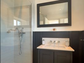 A bathroom with a shower and sink at Bell Cottage Dartmouth