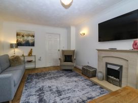 A living room with a sofa and television at Meadow View in Kinmel Bay
