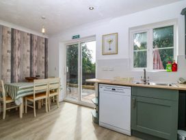 A kitchen with a table and chairs at Meadow View in Kinmel Bay