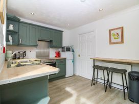 A kitchen with cabinets and a microwave at Meadow View in Kinmel Bay