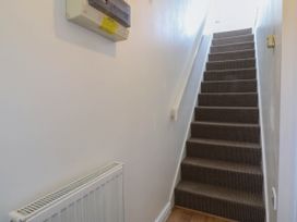 A hallway with stairs and a radiator at Meadow View in Kinmel Bay