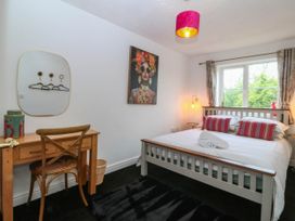 A bedroom with a bed and desk at Meadow View in Kinmel Bay