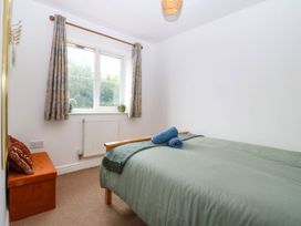 A bedroom with a bed and a window at Meadow View in Kinmel Bay