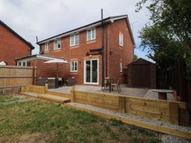 A garden with patio furniture and a shed at Meadow View in Kinmel Bay