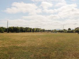 An open field with goalposts and trees at Meadow View in Kinmel Bay
