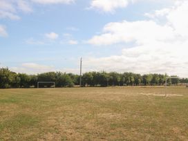 An outdoor football field with a goal and trees at Meadow View in Kinmel Bay