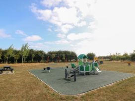 A playground with slides and swings at Meadow View in Kinmel Bay