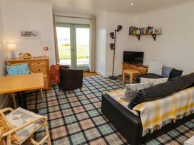 A living room with a sofa and coffee table at Ty Mor in Newport, Pembrokeshire