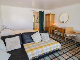 A living room with a sofa and desk at Ty Mor Newport, Pembrokeshire