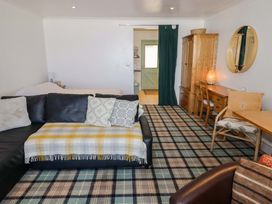 A living room with a sofa and table at Ty Mor in Newport, Pembrokeshire
