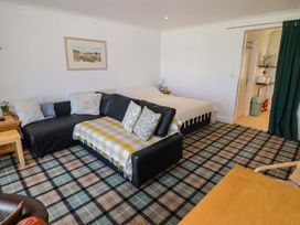 A living room with a sofa and a bed at Ty Mor in Newport, Pembrokeshire