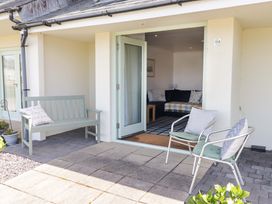 An outdoor seating area with chairs and a bench at Ty Mor in Newport, Pembrokeshire