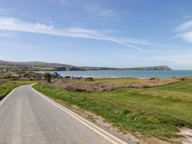 A road leading to the sea with cliffs and grass at Ty Mor in Newport, Pembrokeshire