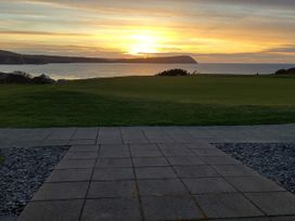 A view of the sunset over the ocean from an outdoor area at Ty Mor in Newport, Pembrokeshire