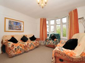 A living room with sofa and armchairs at Porthmeor in Wadebridge