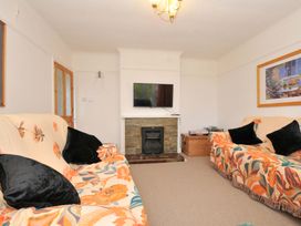 A living room with sofa and television at Porthmeor in Wadebridge