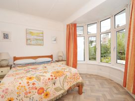 A bedroom with a bed and a window at Porthmeor Wadebridge