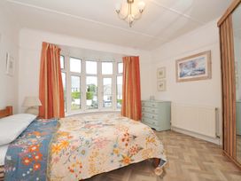 A bedroom with a bed and a chest of drawers at Porthmeor in Wadebridge