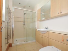 A bathroom with a shower, sink and toilet at Porthmeor in Wadebridge