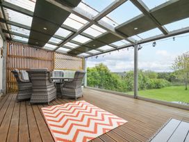 An outdoor area with seating and a table at Porthmeor in Wadebridge