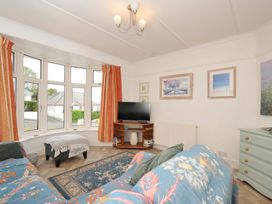 A living room with a TV and sofa at Porthmeor in Wadebridge