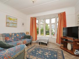 A living room with a sofa and television at Porthmeor in Wadebridge
