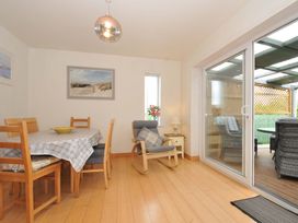 A dining room with a table and chairs at Porthmeor in Wadebridge