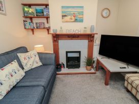 A living room with a sofa and television at Seabreeze in Filey