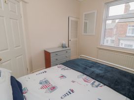 A bedroom with a bed and dresser at Seabreeze in Filey