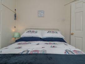 A bedroom with a bed and lamp at Seabreeze in Filey