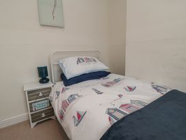 A bedroom with a bed and bedside table at Seabreeze in Filey