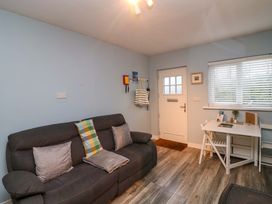A living room with a sofa and a desk at Long Jack's in Ballygarrett, County Wexford