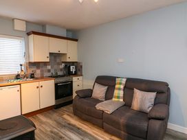 A kitchen with a sofa and appliances at Long Jack's in Ballygarrett, County Wexford