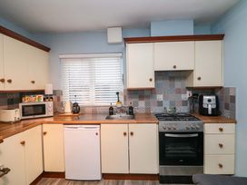 A kitchen with cabinets, appliances, and a sink at Long Jack's Ballygarrett, County Wexford