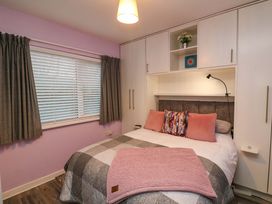 A bedroom with a bed and storage at Long Jack's, Ballygarrett, County Wexford