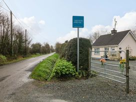 A roadside view of Harmony Lodge with a house and gate in Ballygarrett, County Wexford
