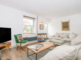 A living room with a sofa and coffee table at Joy's Cottage in Snettisham