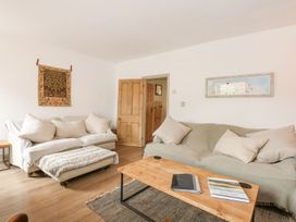 A living room with a sofa and coffee table at Joy's Cottage in Snettisham