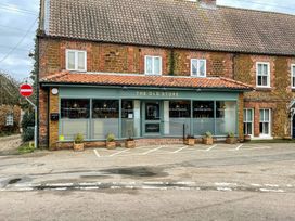 A building with a sign reading The Old Store at Joy's Cottage in Snettisham