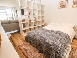 A bedroom with a bed and shelving unit at 11 Fountain Court in Falmouth