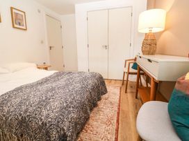 A bedroom with a bed and lamp at 11 Fountain Court in Falmouth
