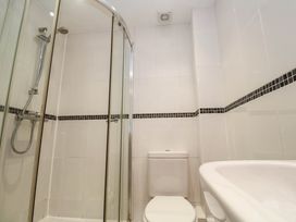 A bathroom with a shower, toilet, and sink at 11 Fountain Court in Falmouth