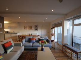 A living room with a sofa and coffee table at 11 Fountain Court in Falmouth